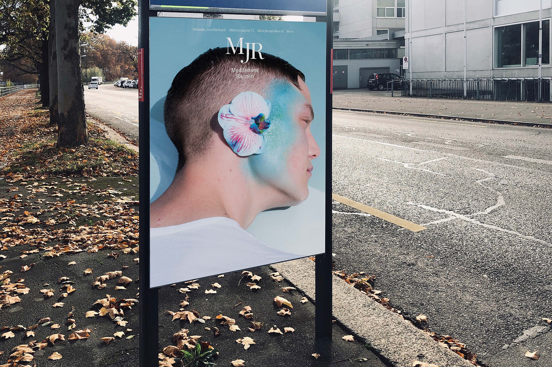 Poster guy with flower ear advertising bern