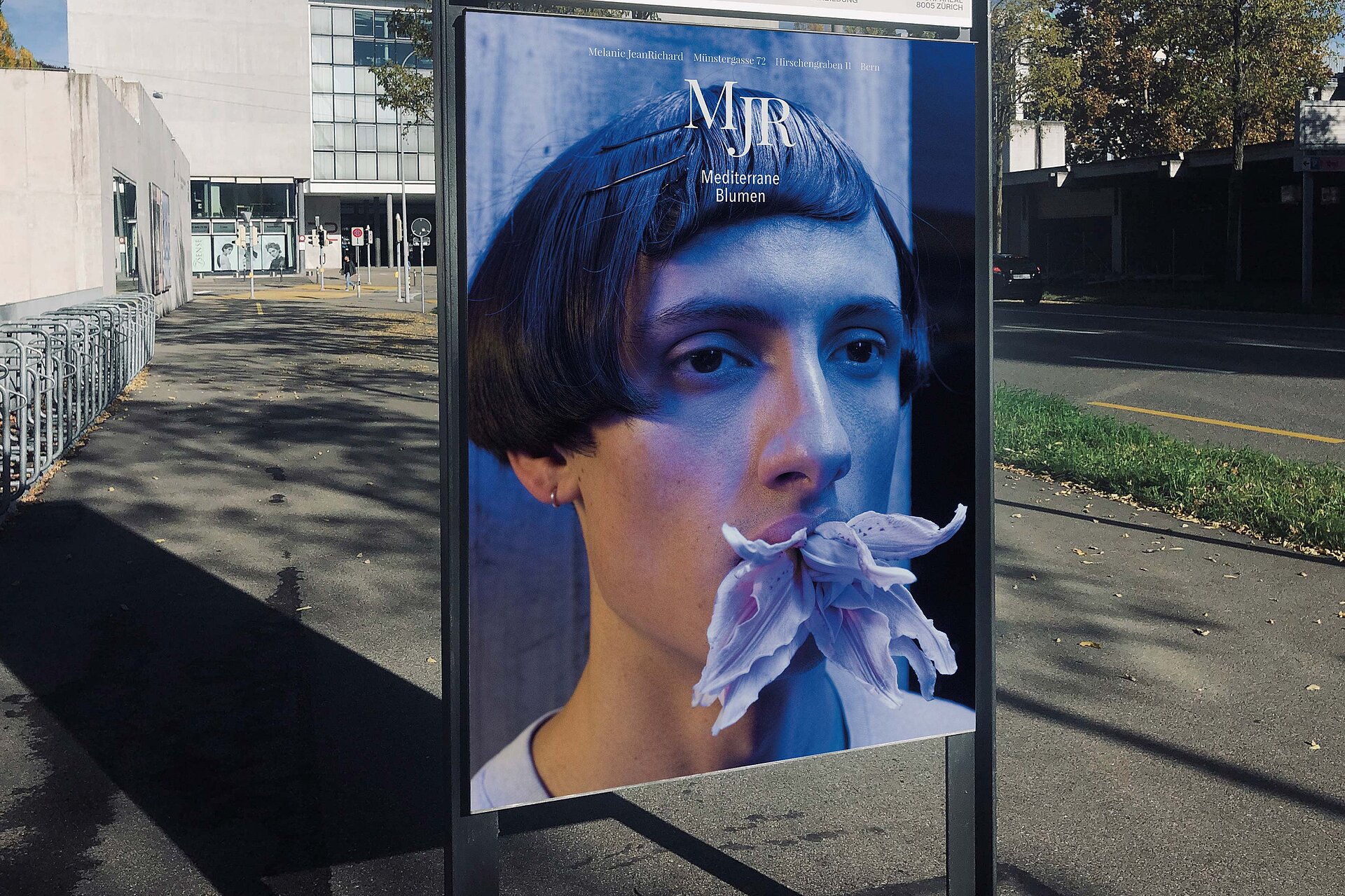 poster guy with flower in mouth werbung bern